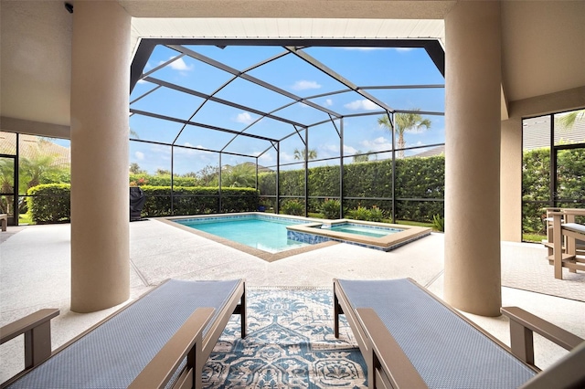 view of swimming pool with a lanai, a patio, and an in ground hot tub