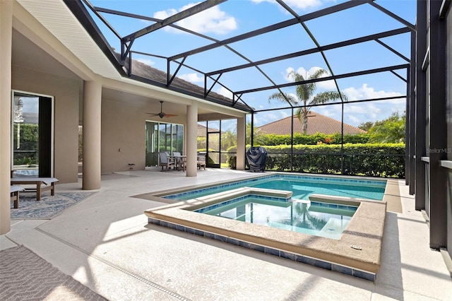 view of pool with ceiling fan, an in ground hot tub, a lanai, and a patio area