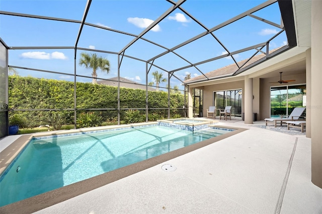 view of swimming pool featuring glass enclosure, an in ground hot tub, ceiling fan, and a patio