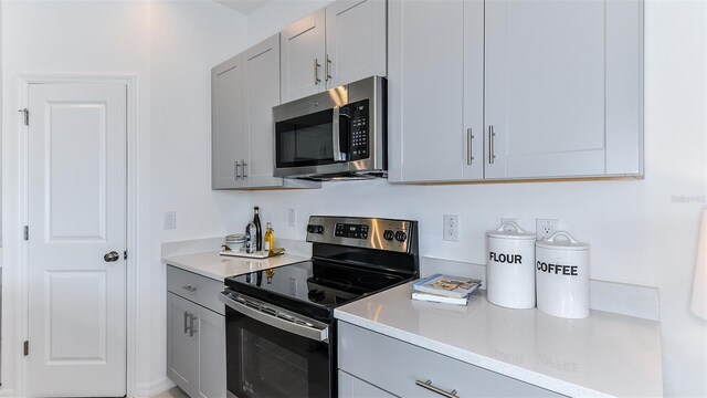 195 River Front Way, Edgewater, FL 32141 - kitchen featuring appliances with stainless steel finishes, gray cabinetry, and light countertops