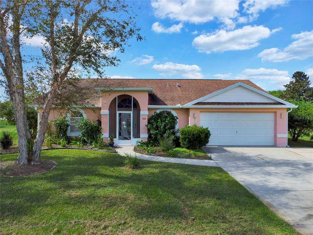 ranch-style home with a front yard and a garage