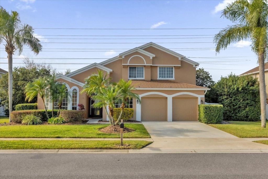 view of front of property with a front yard and a garage