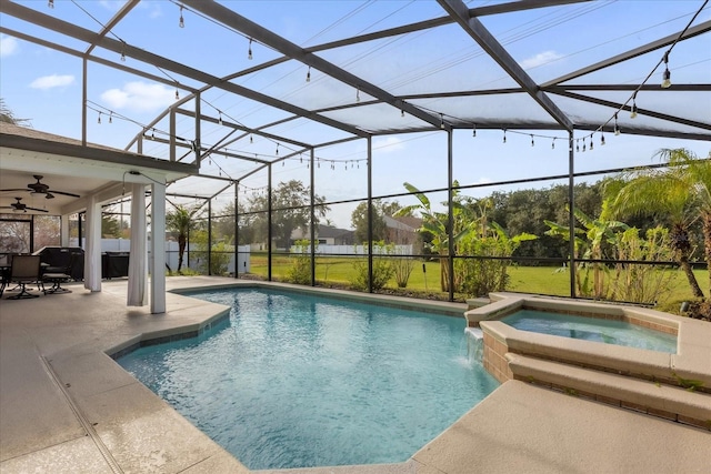 view of pool featuring glass enclosure, an in ground hot tub, and a patio area