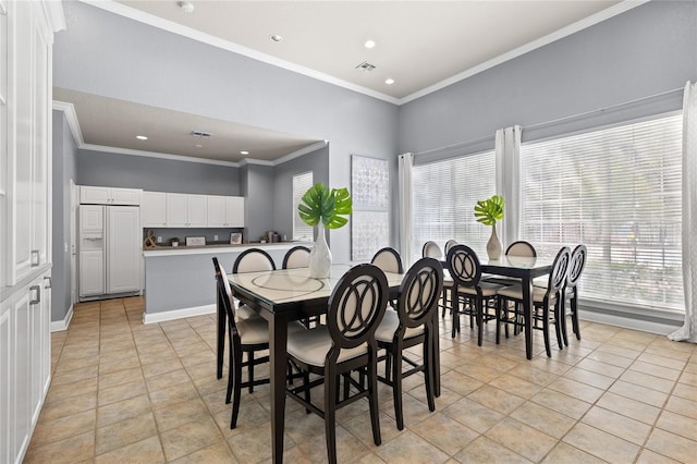 tiled dining area featuring ornamental molding