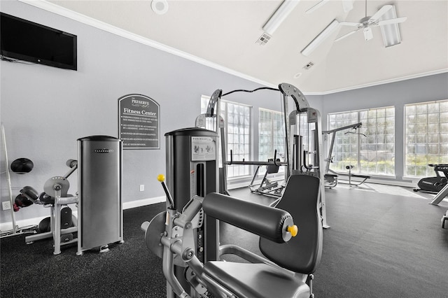 gym with a towering ceiling, crown molding, and ceiling fan