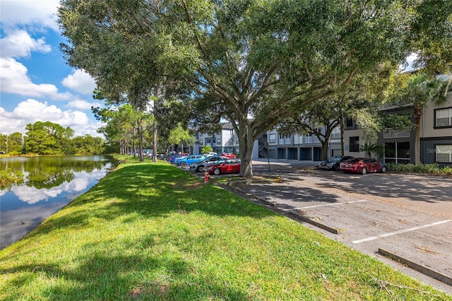 exterior space with a lawn and a water view