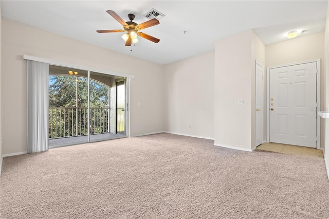 carpeted spare room with ceiling fan