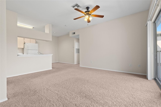 unfurnished living room featuring light colored carpet and ceiling fan