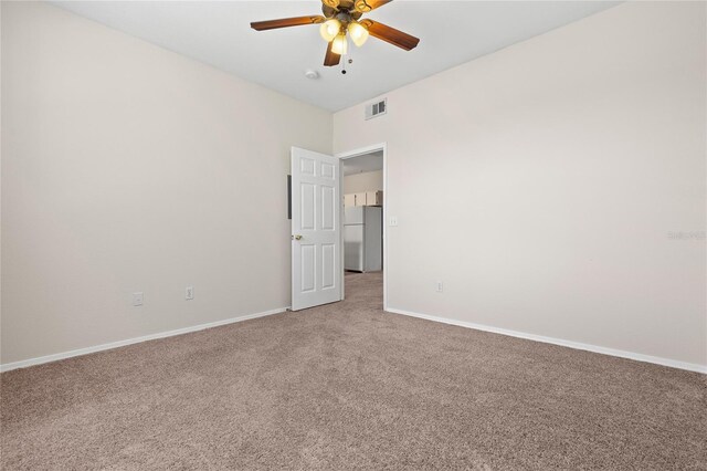 empty room with ceiling fan and carpet flooring