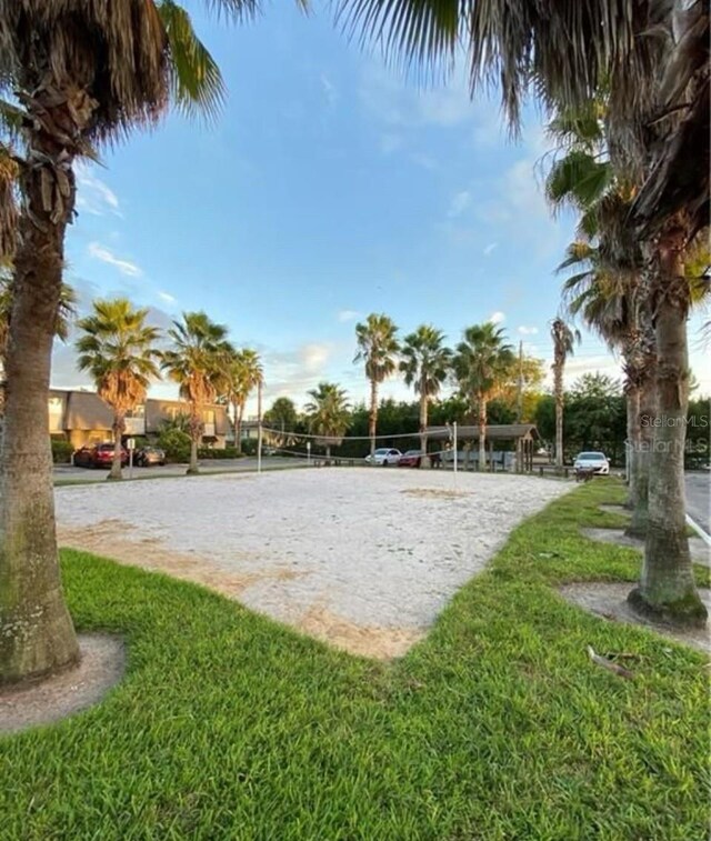 surrounding community featuring a yard and volleyball court