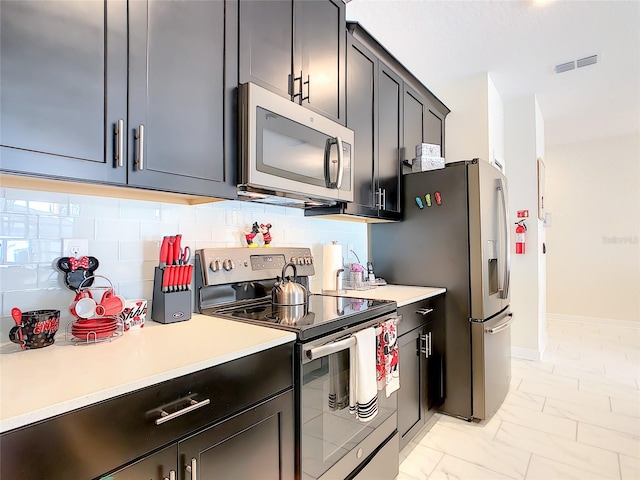 kitchen with backsplash and stainless steel appliances