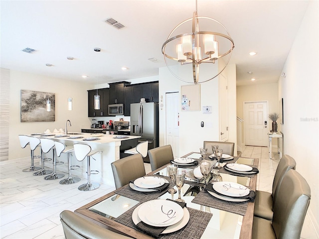 dining area featuring sink and a notable chandelier