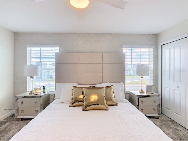 bedroom featuring multiple windows, ceiling fan, and a closet