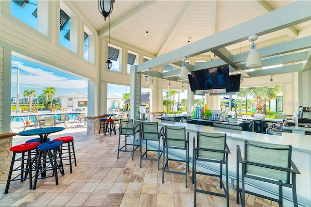 exterior space featuring a bar and ceiling fan