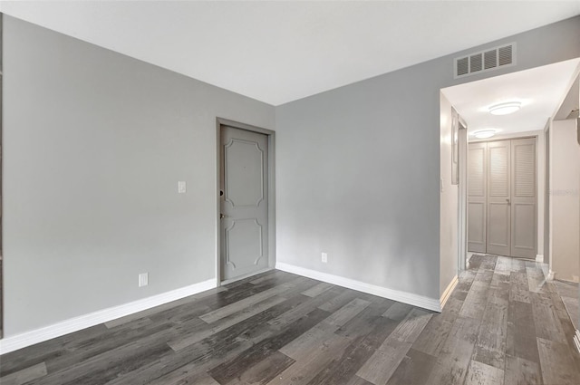 spare room featuring dark hardwood / wood-style floors