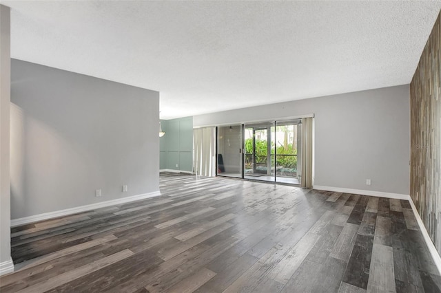 interior space featuring dark wood-style flooring, baseboards, and a textured ceiling