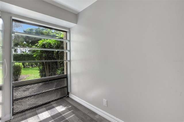 spare room with dark wood-type flooring