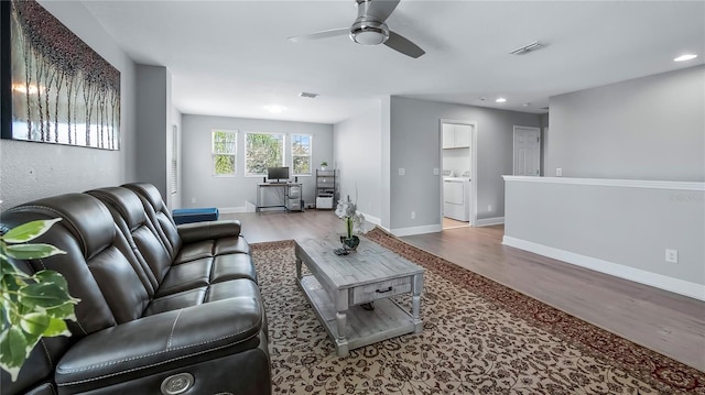 living room featuring ceiling fan and hardwood / wood-style floors