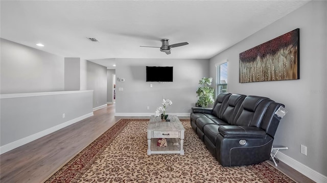 living room featuring wood-type flooring and ceiling fan