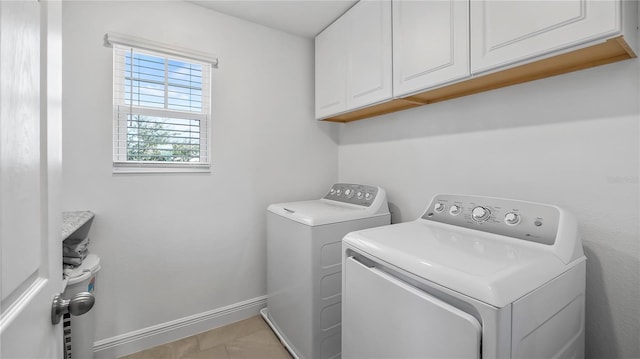 washroom featuring cabinets and washing machine and clothes dryer