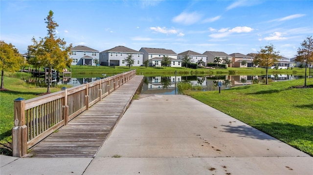 view of property's community featuring a yard and a water view