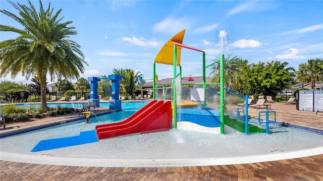 view of jungle gym featuring a community pool