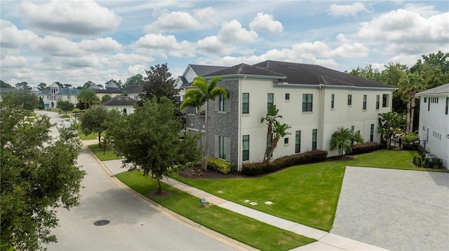 view of side of property with a lawn