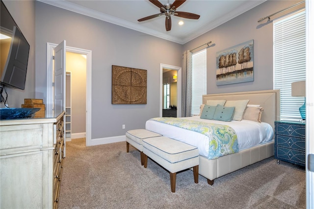 carpeted bedroom featuring ceiling fan and crown molding