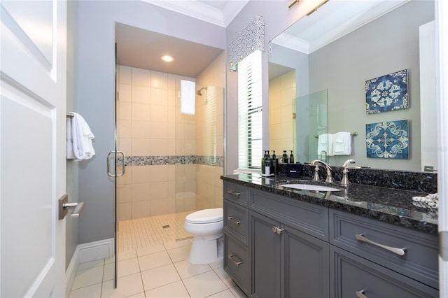 bathroom featuring vanity, a shower with shower door, tile patterned floors, crown molding, and toilet