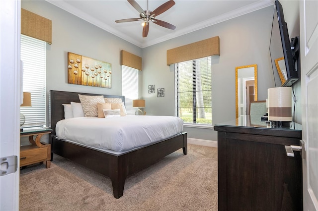 bedroom with ceiling fan, light colored carpet, and crown molding