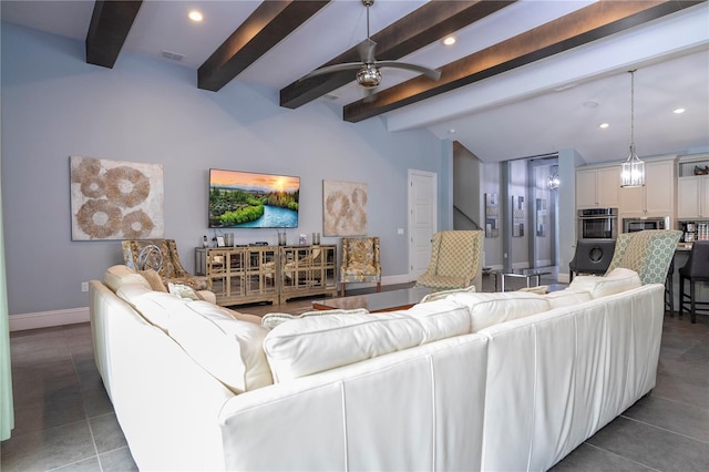 tiled living room with ceiling fan and vaulted ceiling with beams