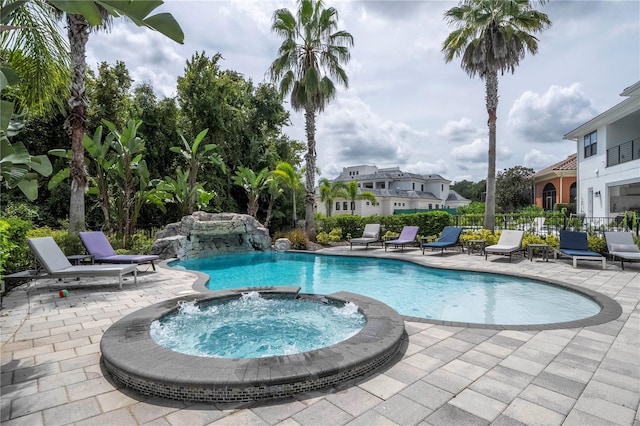 view of swimming pool featuring a patio, an in ground hot tub, and pool water feature