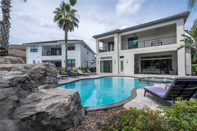 view of swimming pool with an in ground hot tub and a patio