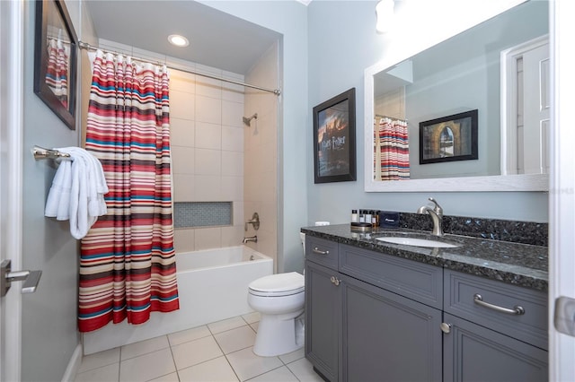 full bathroom featuring shower / bath combo with shower curtain, tile patterned flooring, vanity, and toilet