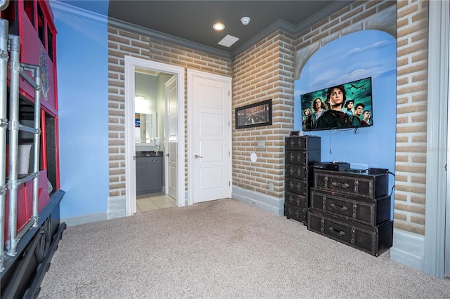 interior space with crown molding, light colored carpet, and brick wall