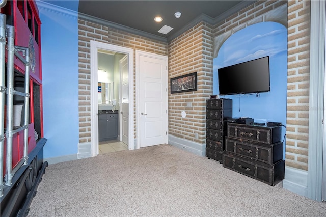 interior space featuring brick wall and crown molding