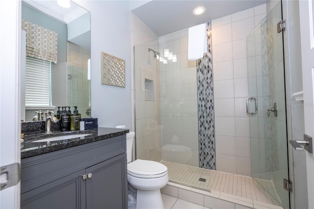 bathroom with vanity, a shower with shower door, tile patterned floors, crown molding, and toilet