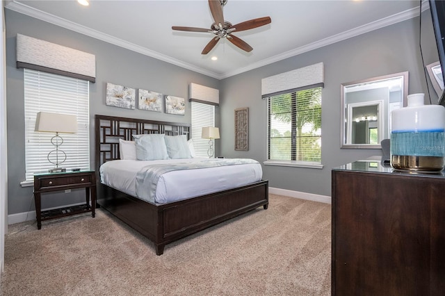 carpeted bedroom with ceiling fan and crown molding