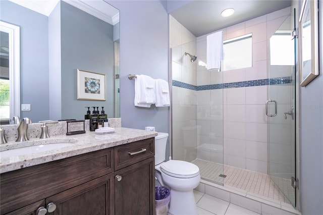 bathroom with vanity, tile patterned floors, walk in shower, crown molding, and toilet