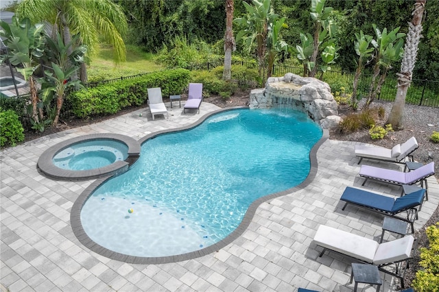 view of swimming pool featuring pool water feature, an in ground hot tub, and a patio area