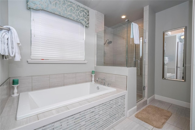 bathroom with tile patterned flooring and separate shower and tub