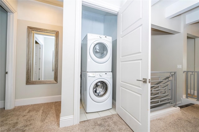 laundry area featuring stacked washer and dryer and light carpet