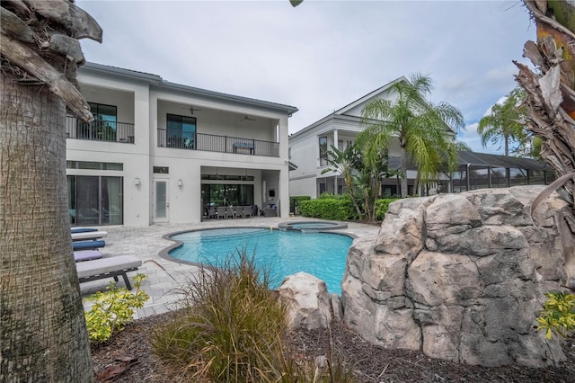 view of swimming pool featuring a patio and an in ground hot tub