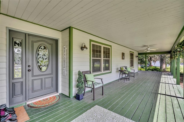 deck featuring covered porch and ceiling fan