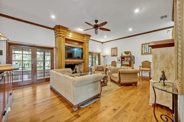 living room featuring ceiling fan, french doors, light wood-type flooring, and ornamental molding