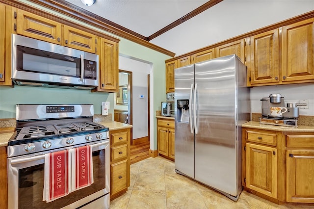 kitchen featuring stainless steel appliances and ornamental molding