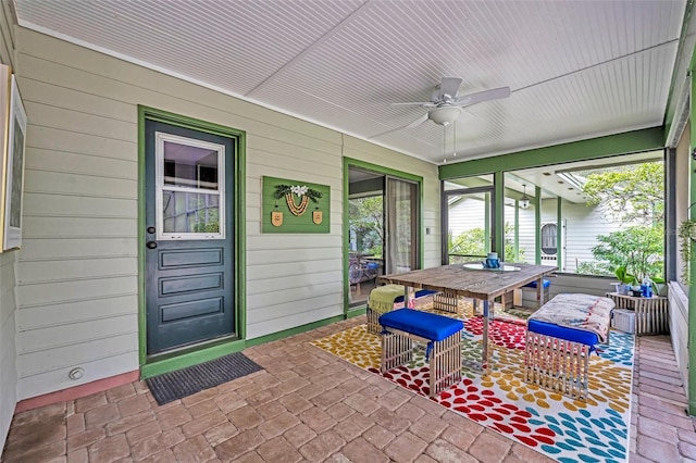 sunroom featuring ceiling fan