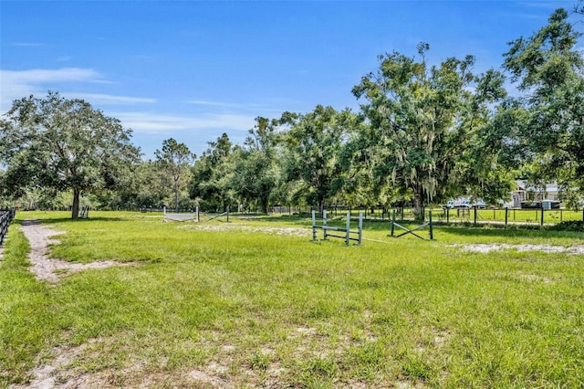 view of property's community with a rural view and a yard