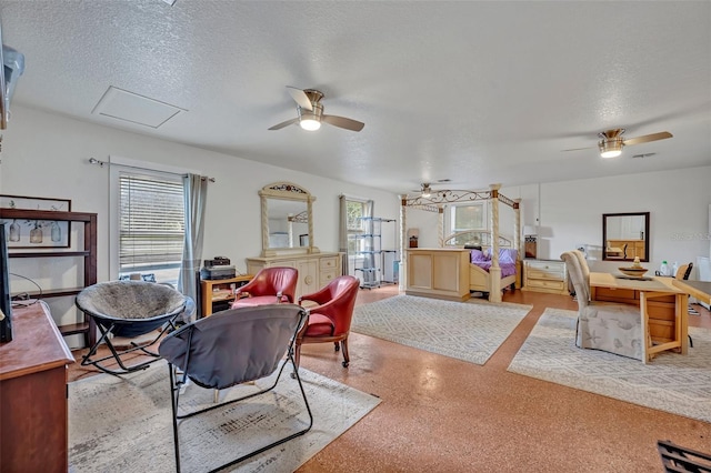 living room with ceiling fan and a textured ceiling