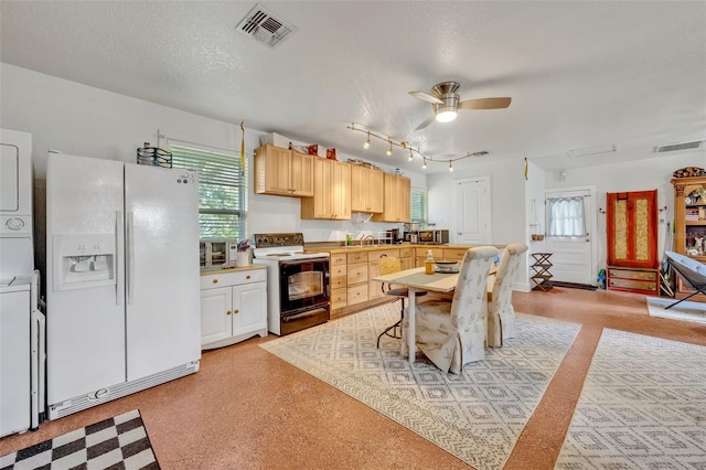 kitchen with a textured ceiling, electric range oven, stacked washing maching and dryer, white refrigerator with ice dispenser, and a breakfast bar